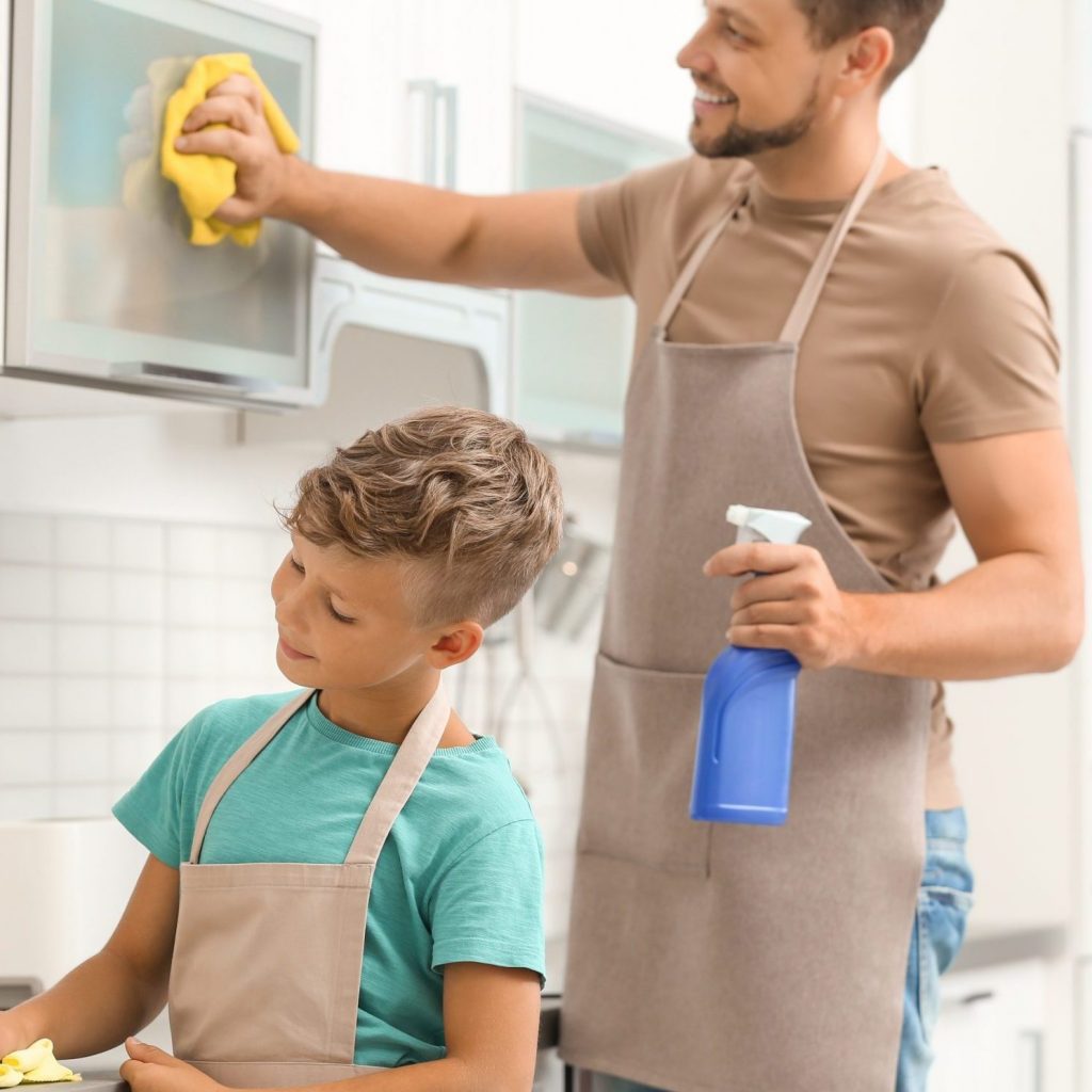 father and son cleaning the kitchen